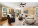 Spacious living room with a stone fireplace, hardwood floors, and a comfortable sectional sofa at 360 Glade Knoll Trail Trl, Fayetteville, GA 30215