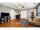 Inviting living room area featuring a comfortable couch, tv, and hardwood floors at 360 Glade Knoll Trail Trl, Fayetteville, GA 30215