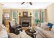 Cozy living room with a stone fireplace, hardwood floors, and large windows for natural light at 360 Glade Knoll Trail Trl, Fayetteville, GA 30215
