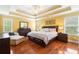 Spacious primary bedroom boasts tray ceilings, hardwood floors, and plenty of natural light at 360 Glade Knoll Trail Trl, Fayetteville, GA 30215