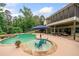 Inviting backyard pool with spa, sun-shelf and covered patio area perfect for outdoor entertaining at 360 Glade Knoll Trail Trl, Fayetteville, GA 30215