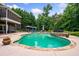 Stunning pool features a rock-ledge spa and an expansive patio, perfect for relaxation at 360 Glade Knoll Trail Trl, Fayetteville, GA 30215
