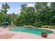 Lush landscaping surrounds this serene backyard pool complete with a rock spa and lounge area at 360 Glade Knoll Trail Trl, Fayetteville, GA 30215