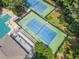 Aerial view of tennis courts and pool area with poolside seating, creating a great outdoor experience at 545 Matterhorn Way Way, Alpharetta, GA 30022