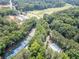 Aerial view of a community featuring tennis courts, a pool, and surrounding green space at 545 Matterhorn Way Way, Alpharetta, GA 30022