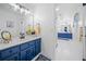 Bathroom boasts double sink vanity with blue cabinets, neutral counter, and modern fixtures at 545 Matterhorn Way Way, Alpharetta, GA 30022