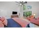 Bright bedroom featuring a ceiling fan, large windows, and a comfortable seating area at 545 Matterhorn Way Way, Alpharetta, GA 30022