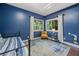 This bedroom features blue walls, hardwood floors, a bed and lots of natural light at 545 Matterhorn Way Way, Alpharetta, GA 30022