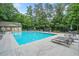 Community pool with lounge chairs, umbrellas, and a fenced perimeter at 545 Matterhorn Way Way, Alpharetta, GA 30022