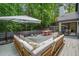 Outdoor living at its finest: large deck with sectional sofa, dining set, and serene woodland backdrop at 545 Matterhorn Way Way, Alpharetta, GA 30022