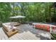 Expansive deck with ample seating, dining area, umbrella, and an enchanting view of the surrounding nature at 545 Matterhorn Way Way, Alpharetta, GA 30022