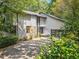 Two-story home featuring light siding, stone accents, dark trim, and an attached garage at 545 Matterhorn Way Way, Alpharetta, GA 30022