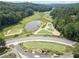 A scenic aerial view of the golf course with a pond and well-maintained fairways at 545 Matterhorn Way Way, Alpharetta, GA 30022