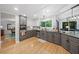 Stylish kitchen featuring stainless steel appliances, granite countertops, and gray and white cabinets at 545 Matterhorn Way Way, Alpharetta, GA 30022
