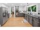 Bright kitchen with stainless steel appliances, grey cabinets, and hardwood floors at 545 Matterhorn Way Way, Alpharetta, GA 30022