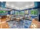 Entertain in this spacious living room with blue walls, recessed lighting, and oversized couches at 545 Matterhorn Way Way, Alpharetta, GA 30022