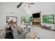 Comfortable living room with stone fireplace, ceiling fan, and views of the backyard at 545 Matterhorn Way Way, Alpharetta, GA 30022