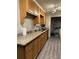 Functional kitchen featuring granite countertops, wood cabinets, and a modern laminate floor at 6305 Eidson Dr, Cumming, GA 30041