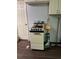 Compact kitchen features classic white appliances, a vintage stove, laminate flooring, and simple white cabinets at 6305 Eidson Dr, Cumming, GA 30041