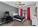 Cozy bedroom with a black bed, desk, red curtains, carpet floors and a modern ceiling fan at 1186 Lincoln Dr, Marietta, GA 30066