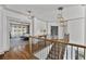 Bright hallway with wood floors, a staircase, and pendant lighting leading to the bedrooms at 1186 Lincoln Dr, Marietta, GA 30066