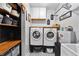 Convenient laundry room featuring white cabinets, hexagon backsplash, and storage shelves at 1186 Lincoln Dr, Marietta, GA 30066