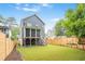 View of home's fenced in yard featuring a well-manicured lawn and stairs to the deck at 2493 Oostanaula Ne Dr, Brookhaven, GA 30319