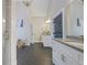 Elegant bathroom featuring dual vanities, herringbone floors, and a walk-in closet at 2493 Oostanaula Ne Dr, Brookhaven, GA 30319