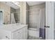 Well-lit bathroom featuring a combined shower and bathtub with grey subway tile surround at 2493 Oostanaula Ne Dr, Brookhaven, GA 30319