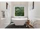 Bright bathroom features a soaking tub, large window, and modern fixtures at 2493 Oostanaula Ne Dr, Brookhaven, GA 30319