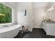 Serene bathroom featuring a soaking tub, natural light, and modern design at 2493 Oostanaula Ne Dr, Brookhaven, GA 30319