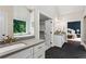 Spacious bathroom featuring double sinks, a bathtub, and a view of a bedroom through walk through closet at 2493 Oostanaula Ne Dr, Brookhaven, GA 30319
