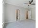 Carpeted bedroom with open doors to the bathroom and a hallway with carpet at 2493 Oostanaula Ne Dr, Brookhaven, GA 30319