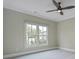A bedroom with a ceiling fan and natural light from the large window at 2493 Oostanaula Ne Dr, Brookhaven, GA 30319