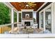 Inviting covered porch featuring a stone fireplace, wooden ceiling, and comfortable seating at 2493 Oostanaula Ne Dr, Brookhaven, GA 30319