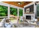 Inviting covered porch featuring a stone fireplace, wooden ceiling, and comfortable seating at 2493 Oostanaula Ne Dr, Brookhaven, GA 30319