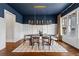 Stylish dining room with a modern chandelier, dark blue ceiling, and a large dining table at 2493 Oostanaula Ne Dr, Brookhaven, GA 30319