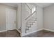 Hallway with wood-look tile, and a door, and stairs with white risers and wood treads at 2493 Oostanaula Ne Dr, Brookhaven, GA 30319