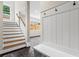 Hallway and stairs features a built-in bench with hooks and storage at 2493 Oostanaula Ne Dr, Brookhaven, GA 30319
