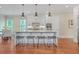 Bright kitchen features a large center island, modern lighting, and sleek countertops at 2493 Oostanaula Ne Dr, Brookhaven, GA 30319