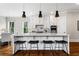 Bright kitchen featuring a marble island with barstool seating and modern pendant lighting at 2493 Oostanaula Ne Dr, Brookhaven, GA 30319