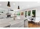 Open concept kitchen and dining area with stainless appliances and a view to the backyard at 2493 Oostanaula Ne Dr, Brookhaven, GA 30319