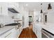 Bright kitchen with stainless appliances, quartz countertops, white cabinets, and hardwood floors at 2493 Oostanaula Ne Dr, Brookhaven, GA 30319