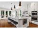 Gourmet kitchen with white cabinets, a large island, stainless steel appliances, and a marble backsplash at 2493 Oostanaula Ne Dr, Brookhaven, GA 30319