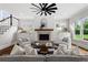 Bright living room with a fireplace, ceiling fan, hardwood floors, and natural light at 2493 Oostanaula Ne Dr, Brookhaven, GA 30319