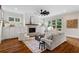 Spacious living room with hardwood floors, fireplace, ceiling fan, and modern decor at 2493 Oostanaula Ne Dr, Brookhaven, GA 30319