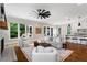 Open concept living room with lots of natural light and hardwood floors, that flows into kitchen at 2493 Oostanaula Ne Dr, Brookhaven, GA 30319