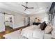 Well lit main bedroom with decor, hard wood floors, and a ceiling fan at 2493 Oostanaula Ne Dr, Brookhaven, GA 30319