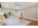 Spacious bedroom features hardwood floors, tray ceilings, and a sliding barn door to bathroom at 2493 Oostanaula Ne Dr, Brookhaven, GA 30319