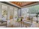 Covered porch with white furniture, a wooden ceiling, and french doors to the dining room at 2493 Oostanaula Ne Dr, Brookhaven, GA 30319